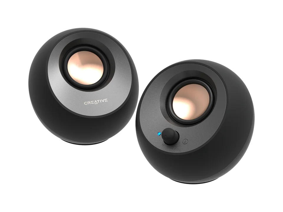 Pair of black Creative Pebble V3 round desktop speakers with copper-coloured drivers