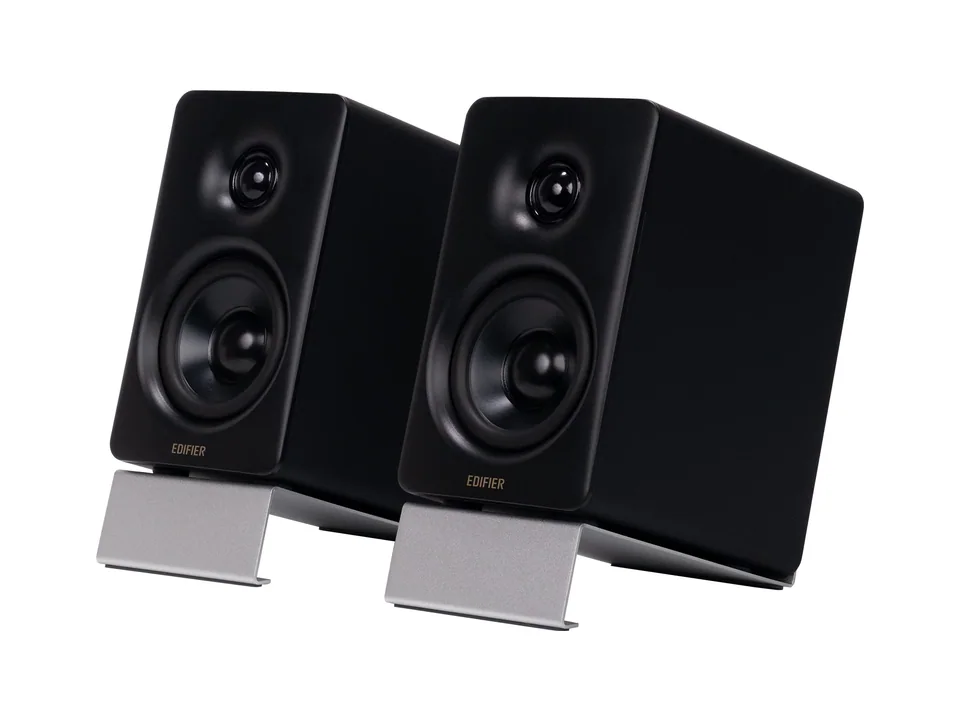 Pair of black Edifier M60 desktop speakers on their tilted aluminium stands, three-quarter view