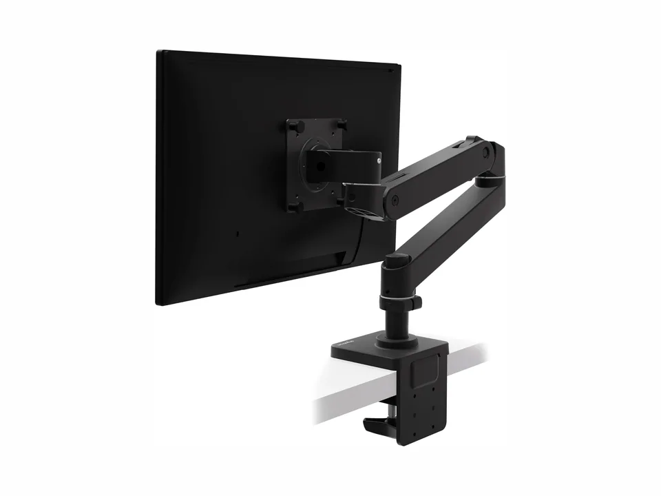 Matte black Ergotron LX Pro monitor arm clamped to a desk holding a monitor, rear three-quarter view