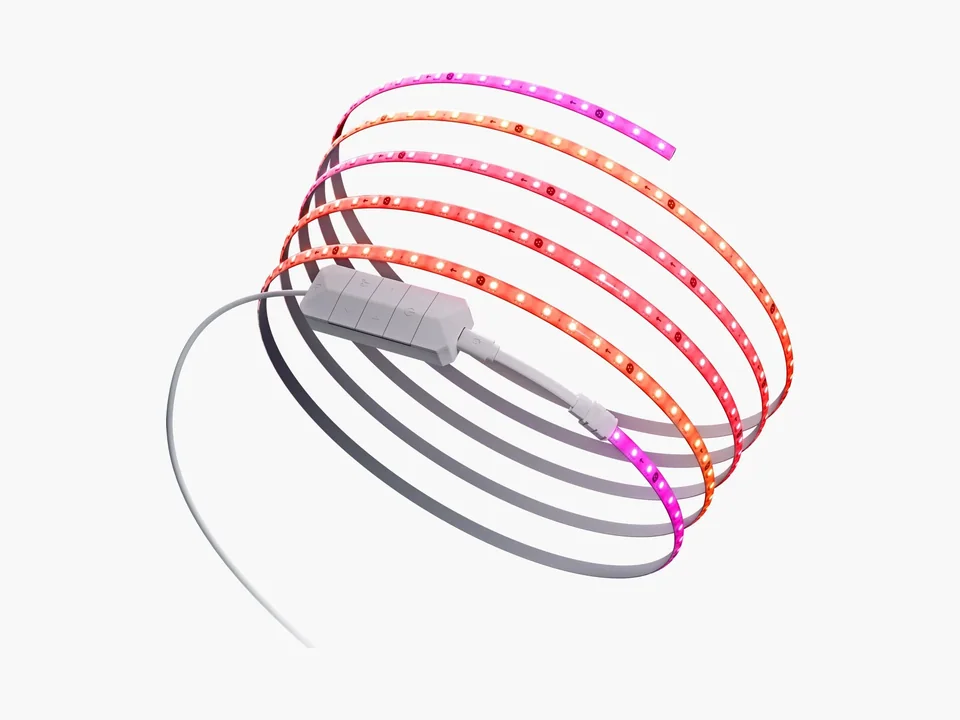 Nanoleaf multicolor LED strip coiled with its white inline controller, glowing pink and orange, on a light grey background