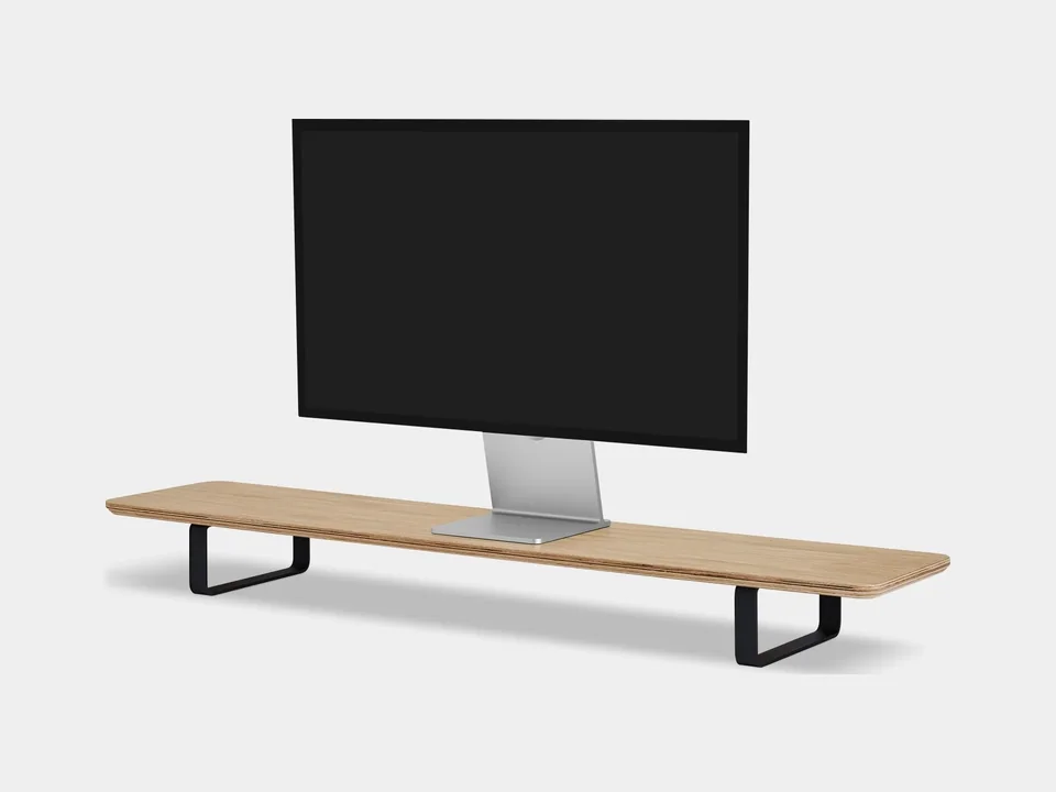 Oakywood Desk Shelf in solid oak with black steel legs holding a monitor, on a light grey background