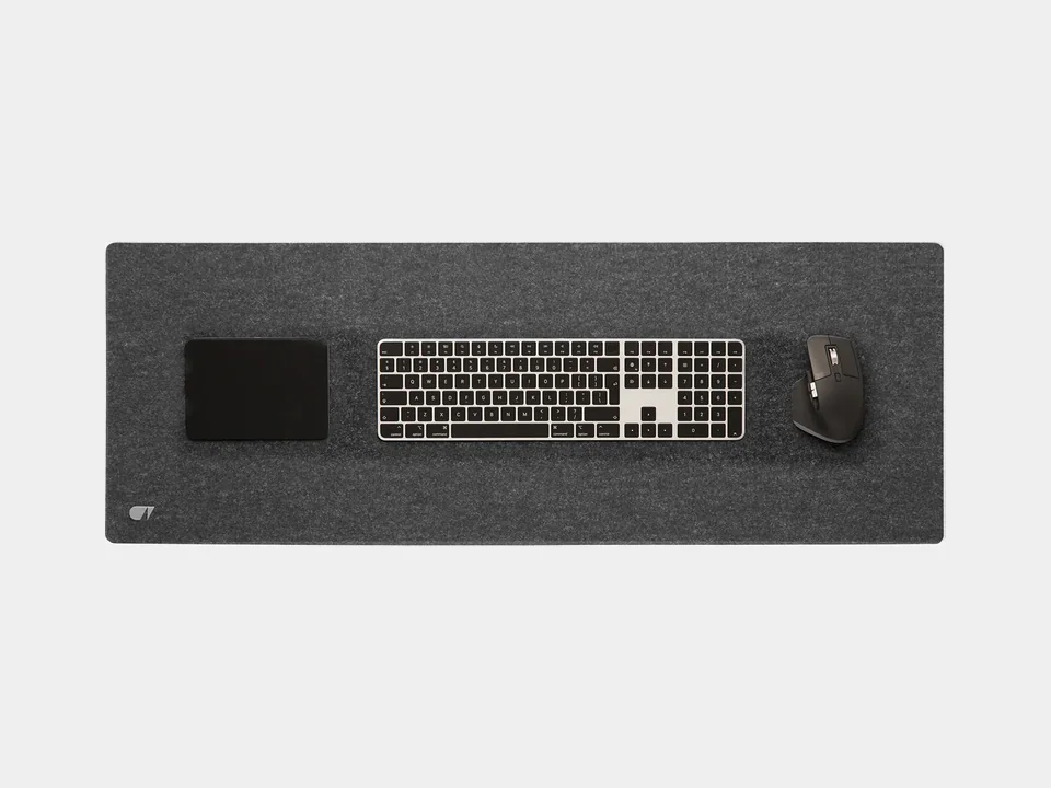 Anthracite Oakywood felt and cork desk mat seen from above, shown with a keyboard, mouse and pad that are not included