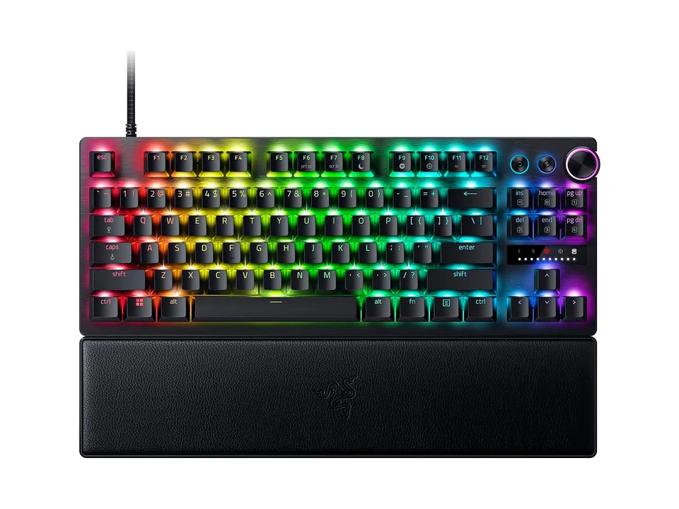 Razer Huntsman V3 Pro TKL keyboard with rainbow RGB lighting and wrist rest, three-quarter view on a white background
