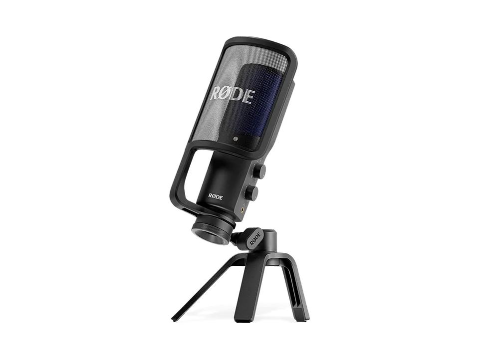 Black RØDE NT-USB+ microphone with pop filter on its tripod desk stand, three-quarter view